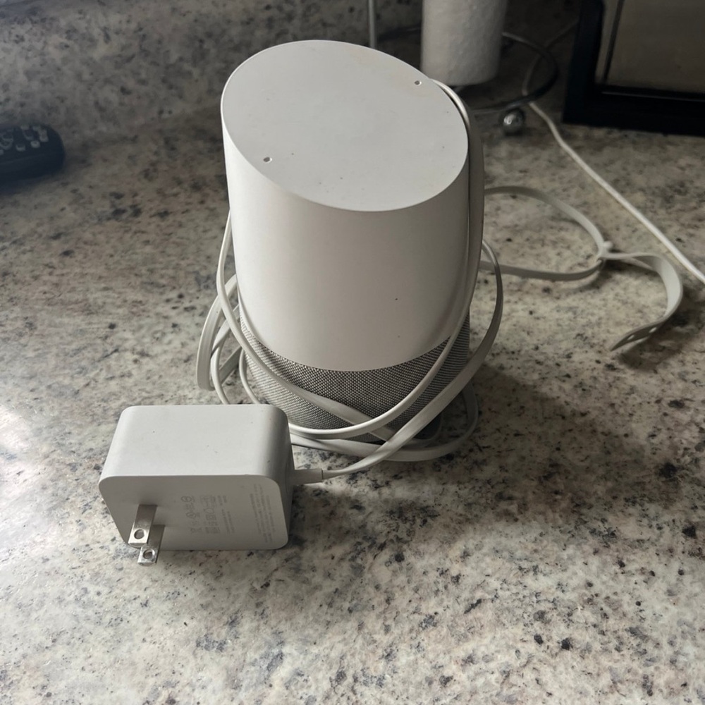 White Google home smart speaker with Charger